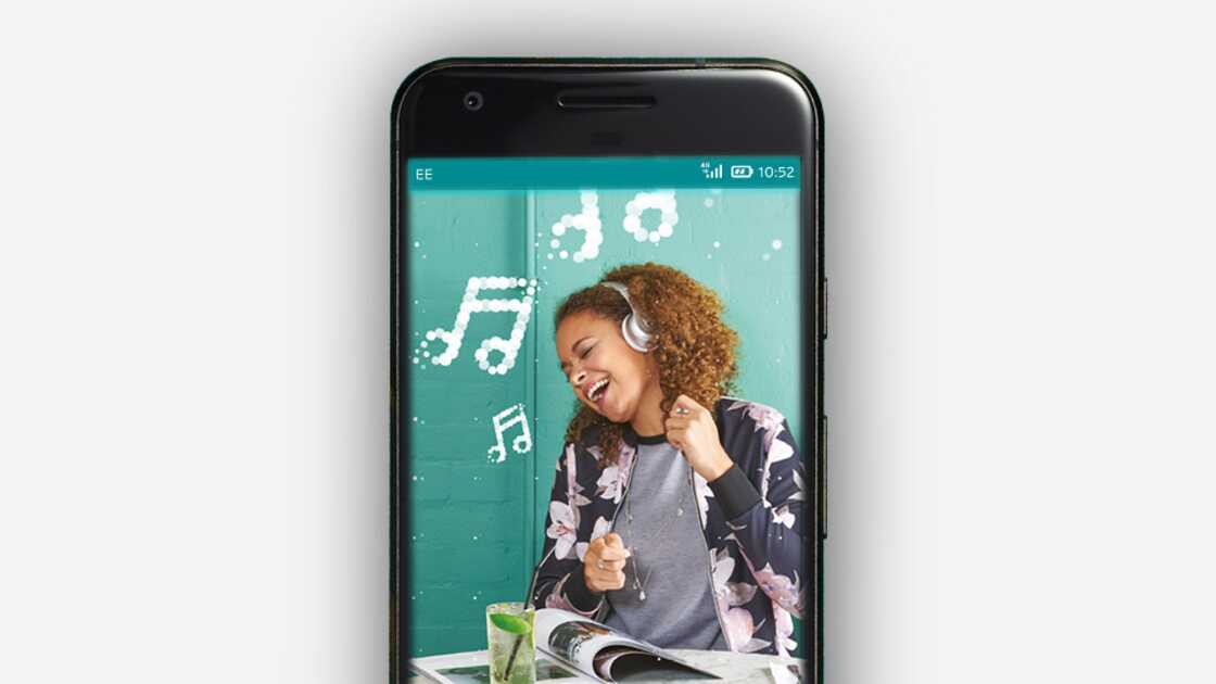 Phone screen displaying a woman singing along to music coming out of her headphones