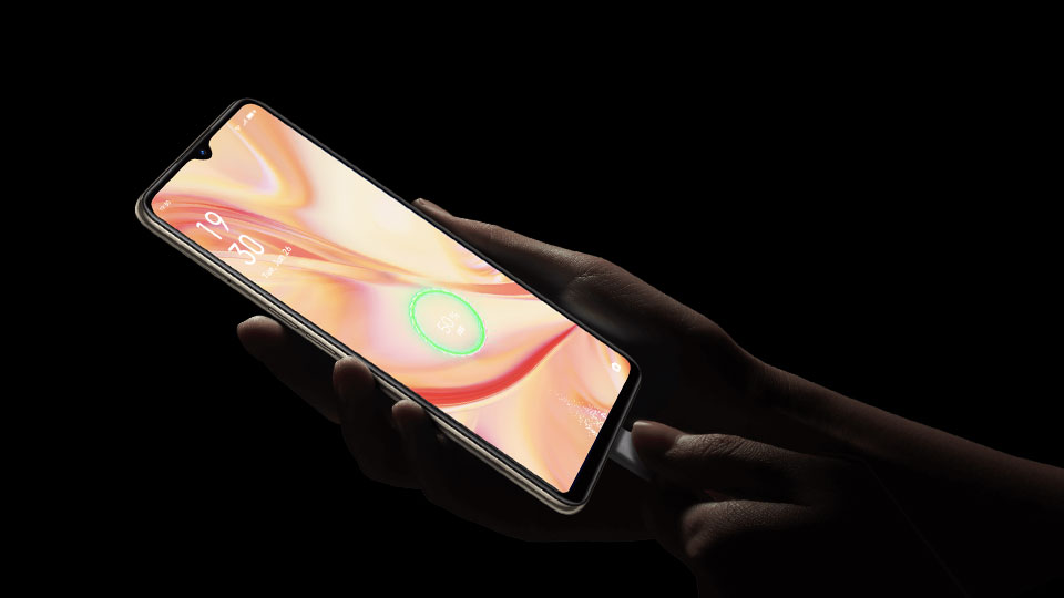 the OPPO Find X2 Lite being held and charged