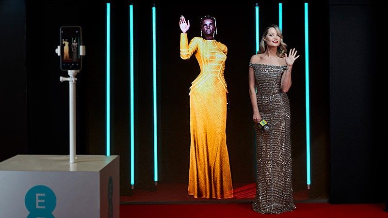 Digital supermodel Shudu poses with EE BAFTAs red carpet host Laura Whitmore
