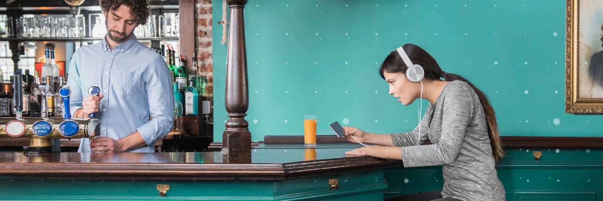 Woman in a pub looking at her phone